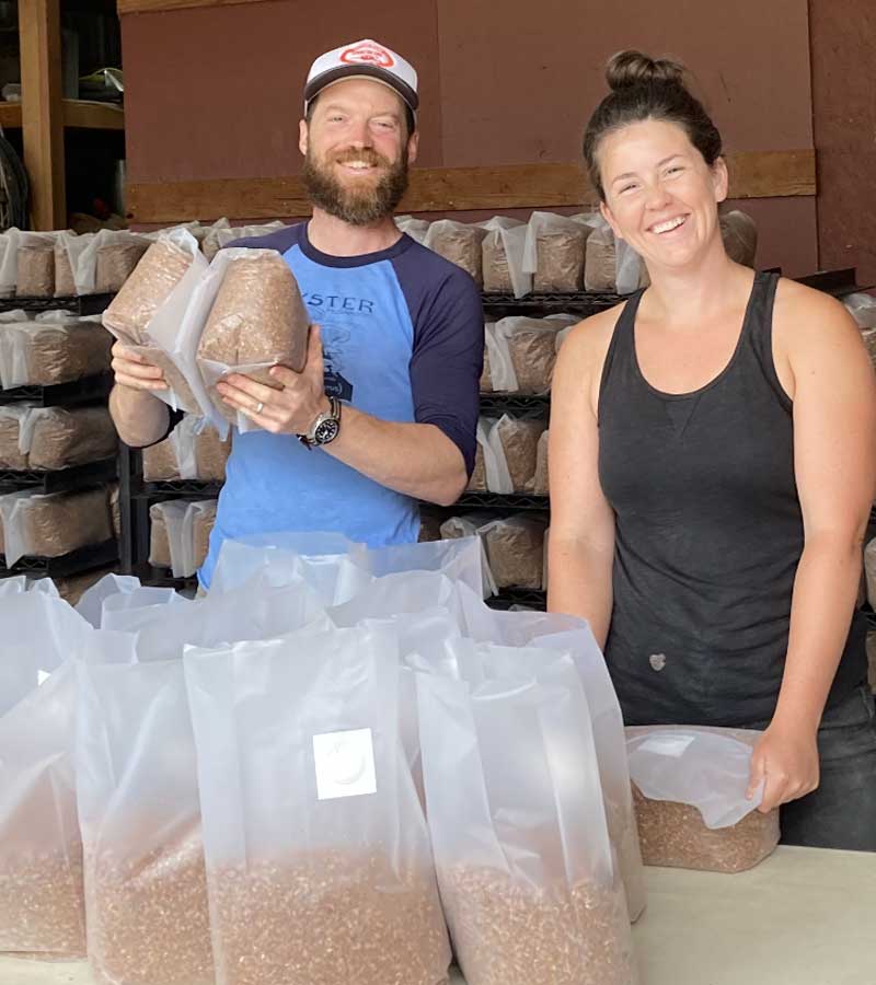 Alex and Kylie bagging mushroom substrate.