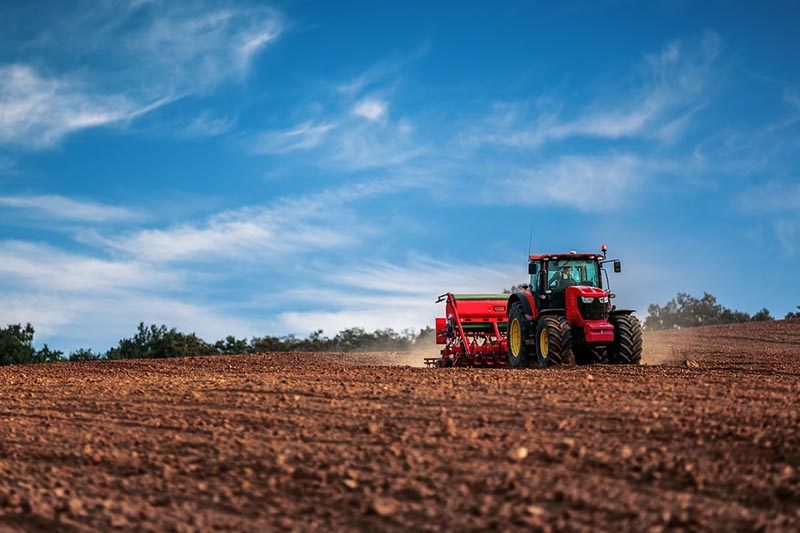 tractor disturbing topsoil and the mycelium fungal networks that inhabit it