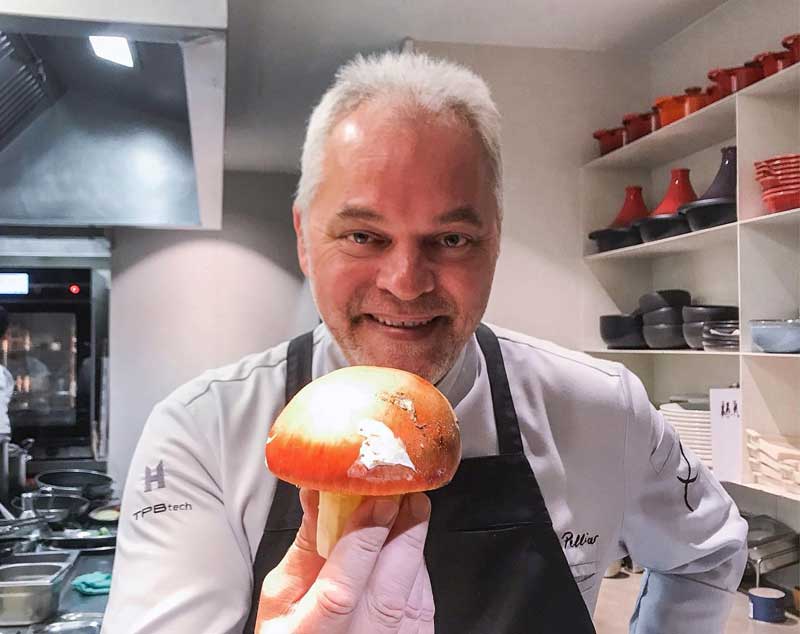 Chef Xavier Pellicer holding a large Caesar's Mushroom.